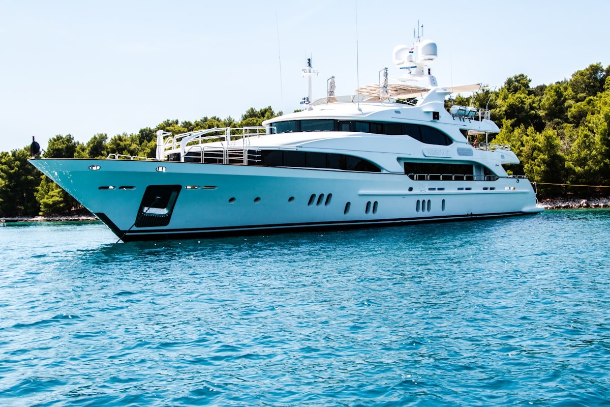 Luxury superyacht anchored in calm Mediterranean waters at golden hour