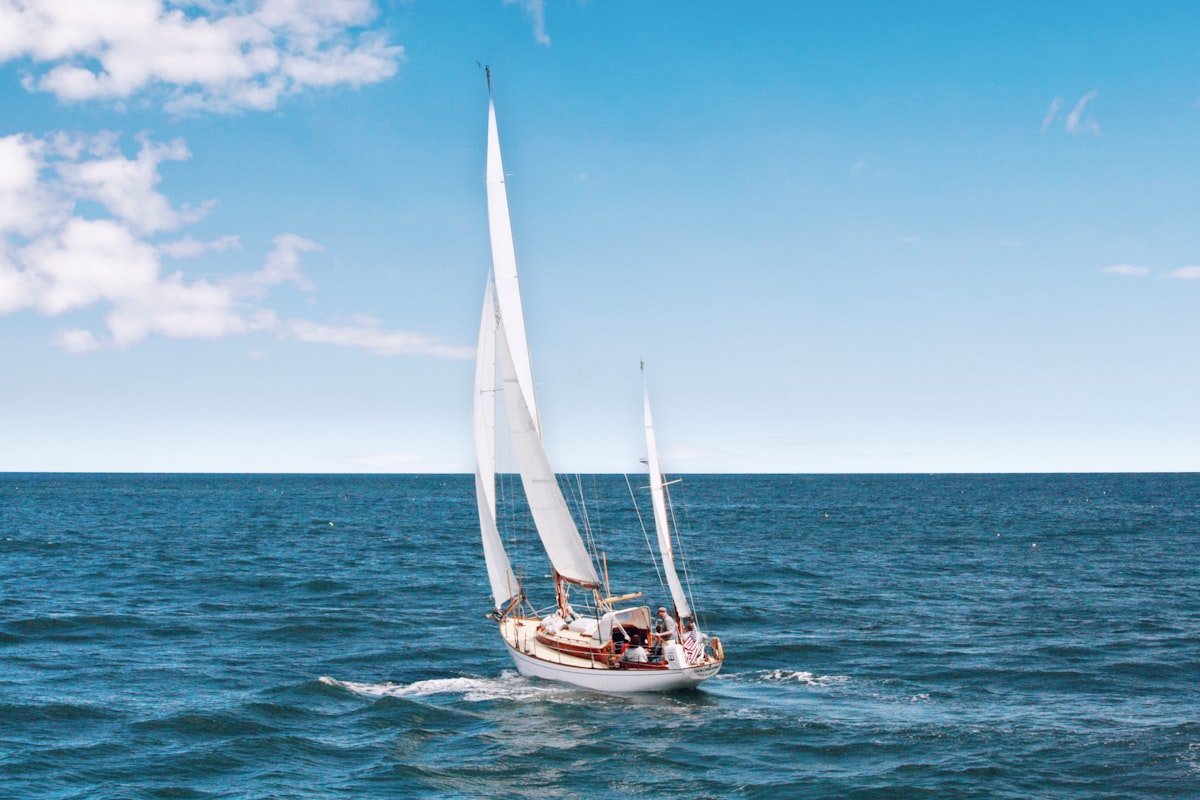 Luxury crewed yacht anchored in crystal-clear turquoise water in the Mediterranean